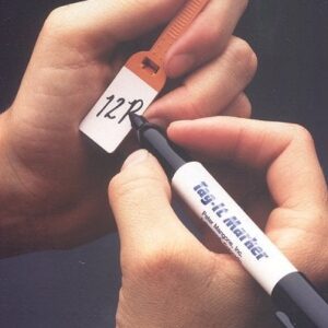 Hand holding two labeled cables or cords against a dark background.