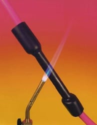 Two makeup brushes with black handles and metallic ferrules on a gradient pink and yellow.