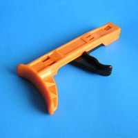 Orange wooden camera grip with black rubber handle on blue background.
