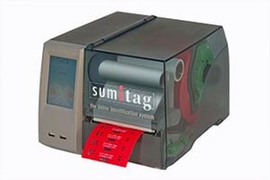 A thermal label printer with a red paper tray and control panel.