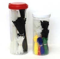 Two clear plastic storage containers with red and clear lids holding black cable ties and colored.
