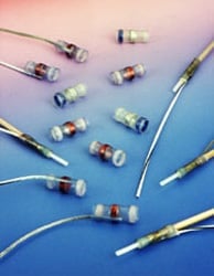 Electronic components and wires arranged on a blue surface.