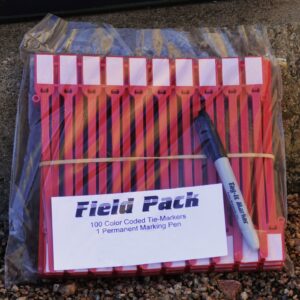 Field Pack containing 100 color-coded tie-markers and one permanent marking pen on gravel surface.