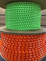 Stacked rolls of green and red textured rope or cord material.