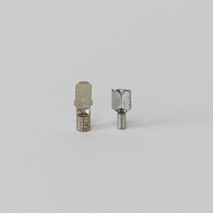 Two metal electrical connectors or terminals on a white background.