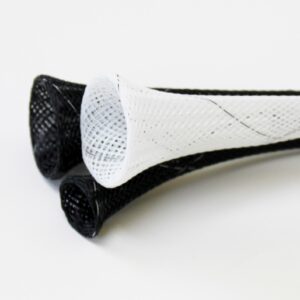 Lacrosse stick head with black and white mesh netting on white background.