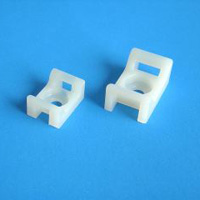 Two white plastic cable clips or wire organizers on a blue background.