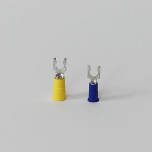Two insulated spade connectors, one yellow and one blue, with metal fork terminals on a white.