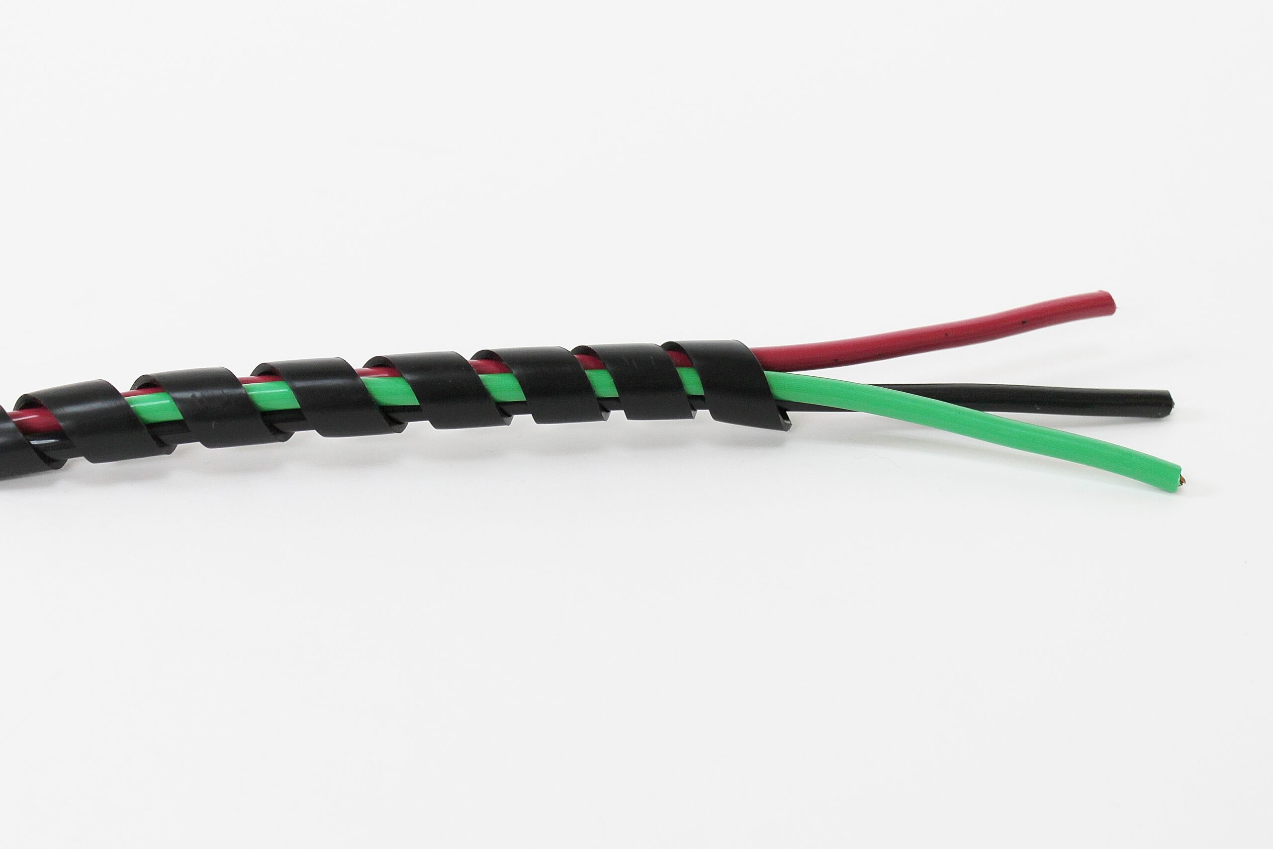 Black spiral cable wrap with green and red wires partially unwrapped.