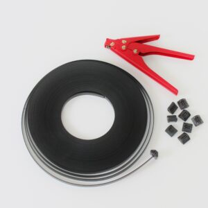 Red cable tie gun with black adhesive tape roll and fasteners on white background.