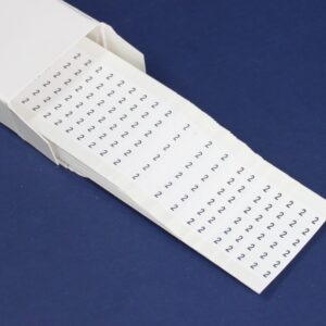 White tape dispenser with printed numbers arranged in rows on a dark blue background.