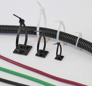 Cable management clips holding various colored wires and a corrugated cable sleeve.