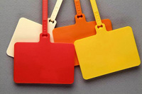 Colorful fabric tote bags in red, orange, and yellow arranged on a gray surface.