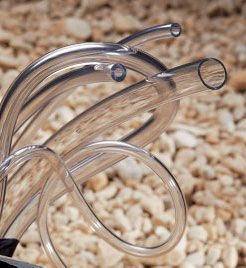 Surgical instruments including forceps and scissors arranged on a textured surface.