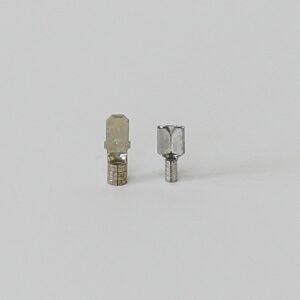 Two metal electrical connectors on a gray background.