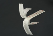 White origami bird with folded wings against a dark gray background.