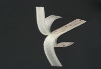 White origami bird with folded wings against a dark background.