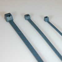 Three blue cable ties arranged in a row on a white surface.
