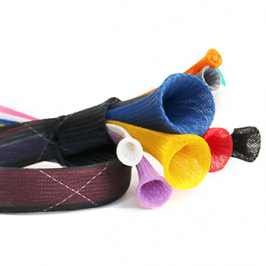 Person lying down holding three colorful dumbbells in their hands.