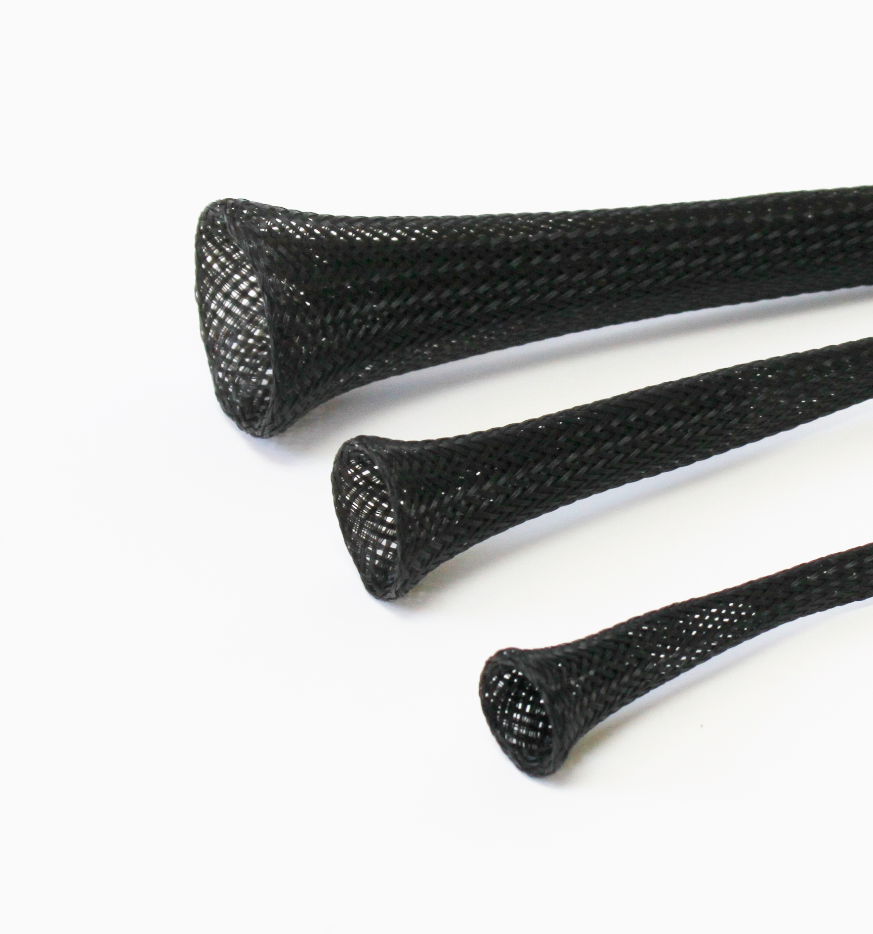 Three black expandable mesh cable sleeves in decreasing sizes arranged diagonally on a white.