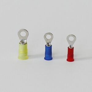 Three insulated ring terminals in yellow, blue, and red arranged in a row.