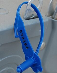 Blue plastic bottle holder with clear top clip attached to white surface.