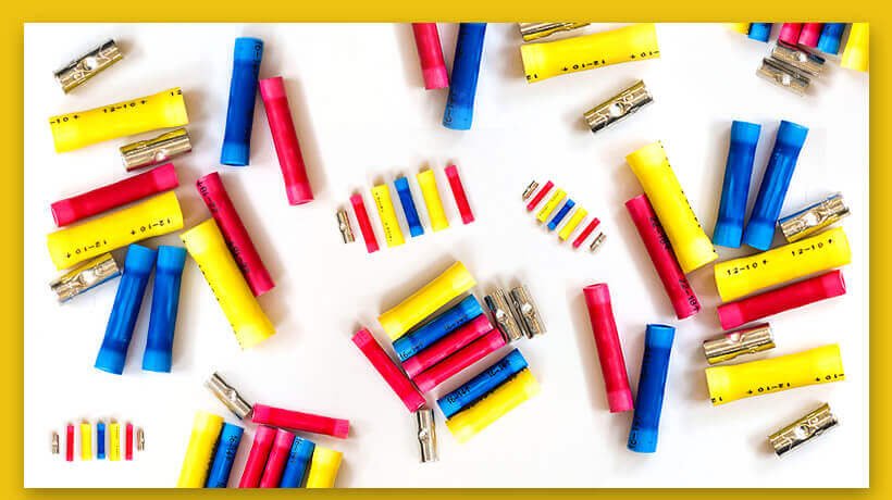 Colorful school supplies including yellow rulers, blue and red markers, and pencils arranged.